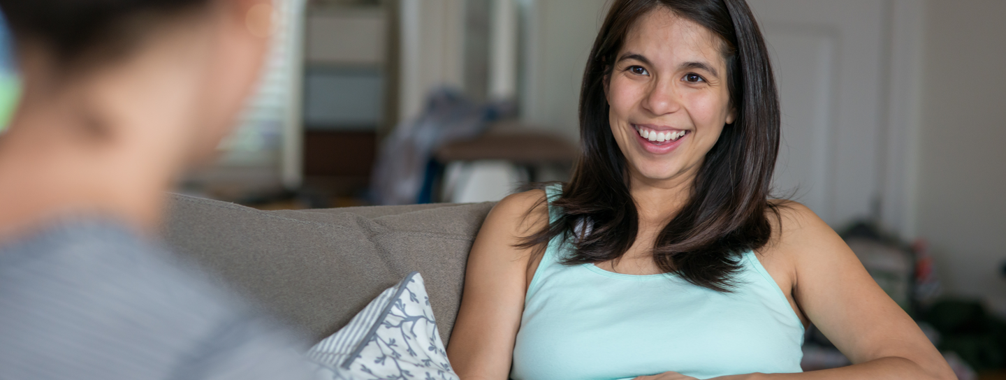 A pregnant woman on a couch