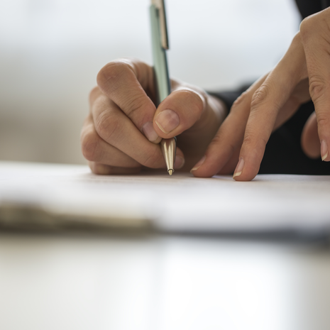 Person writing with a pen