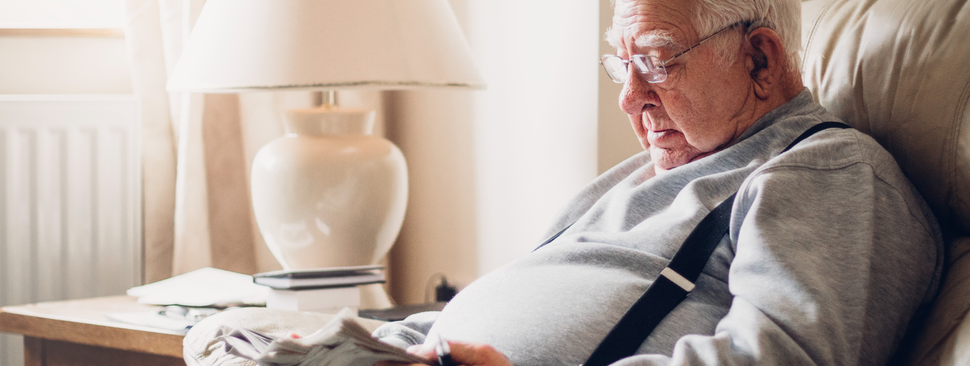 Senior man sitting alone at home