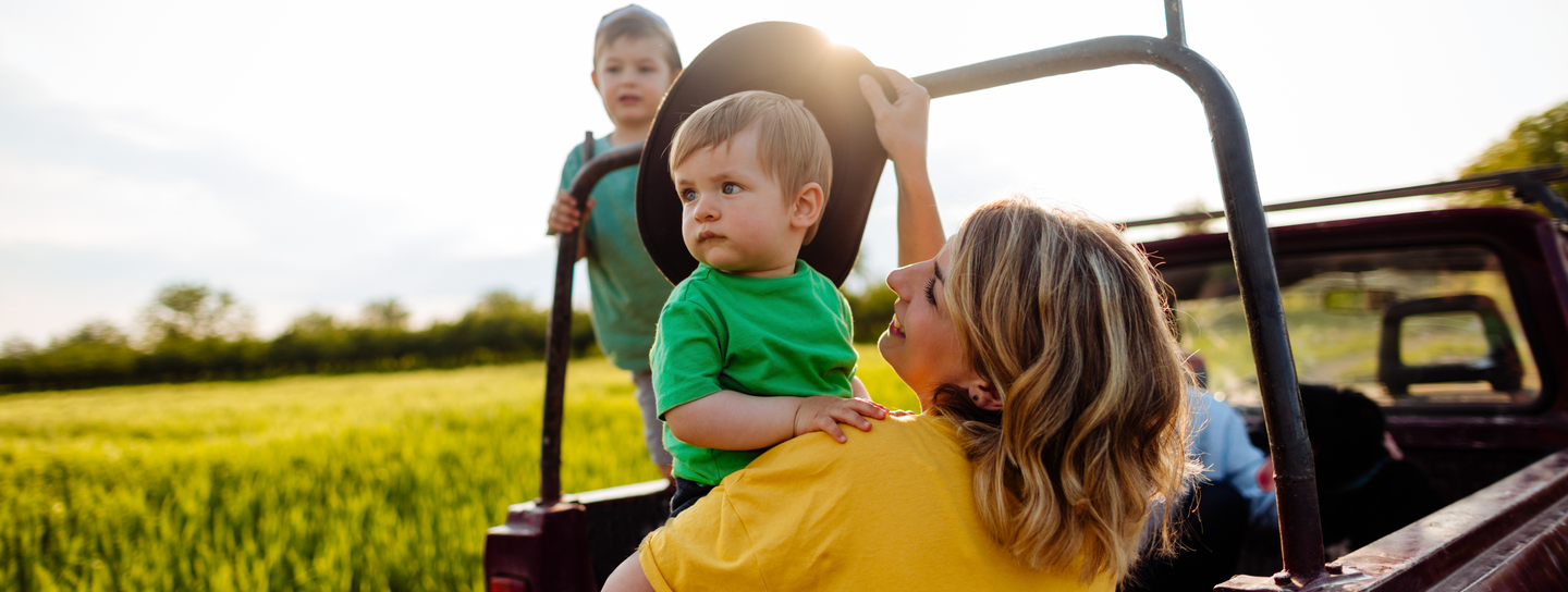 In a pick-up truck at family farm