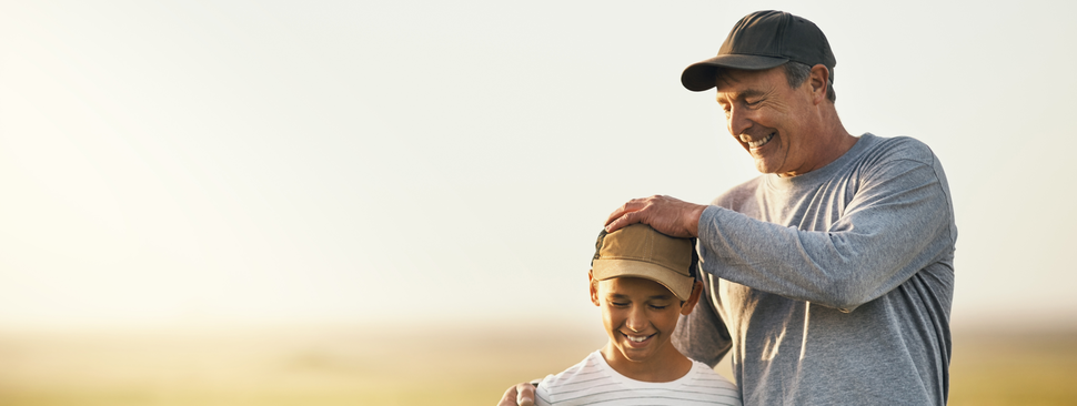 Grandfather and grandson in a cornfield