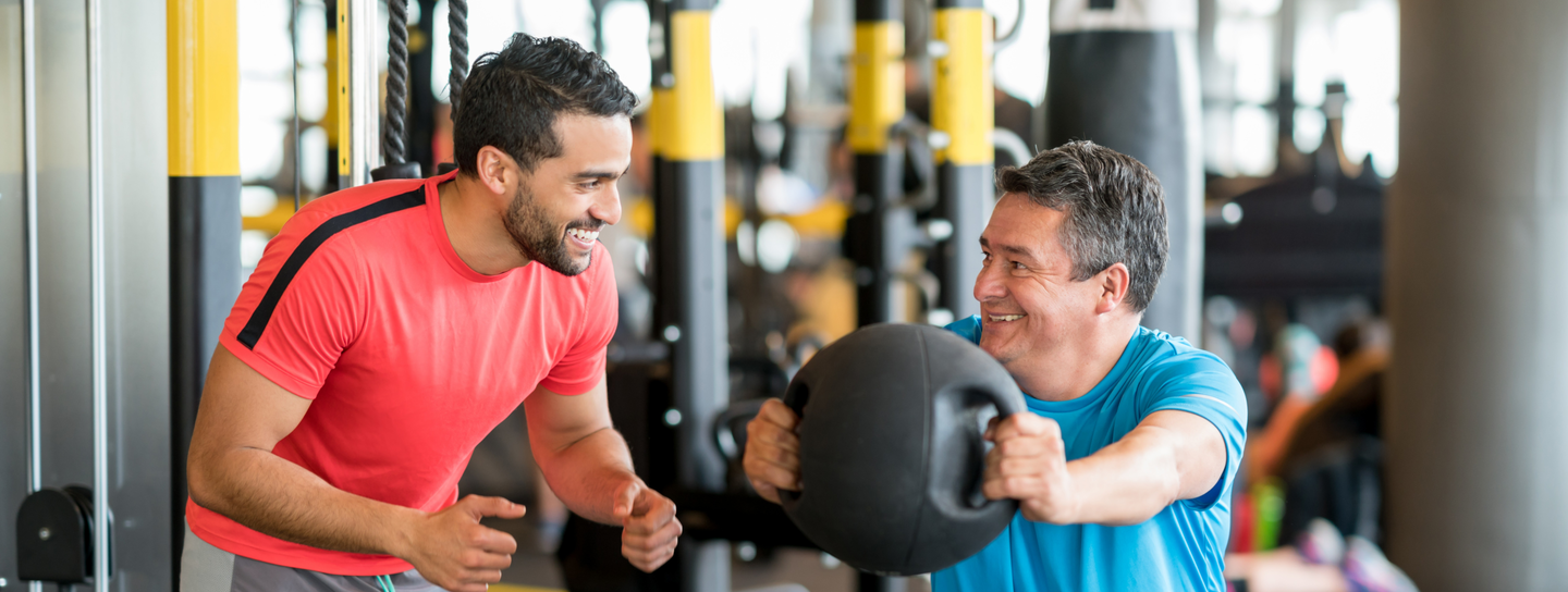 mature man exercising with a trainer
