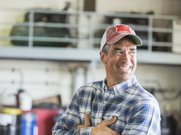 A well-rested man standing in his garage. 