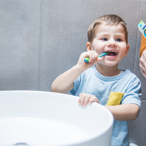 A little boy brushing his teeth