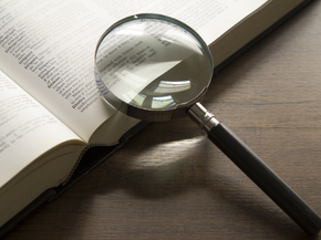 Magnifying glass on book.