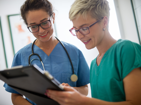 Doctor and nurse look at clipboard