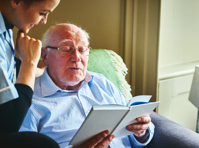 Volunteer reads to elderly man