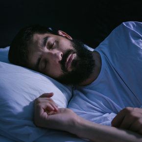 Man sleeping in bed.