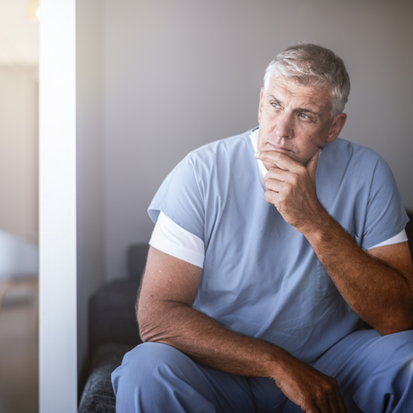 Older male provider looking thoughtful