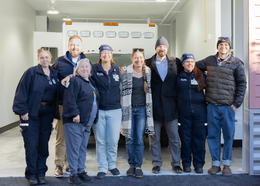 Staff in front of Air St. Luke's vehicle shelter.