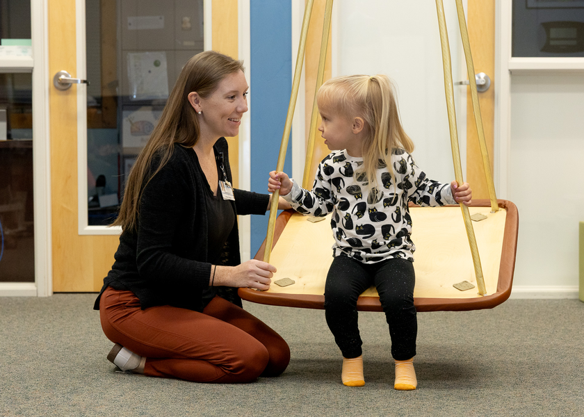 Pediatric patient working with physical therapist. 