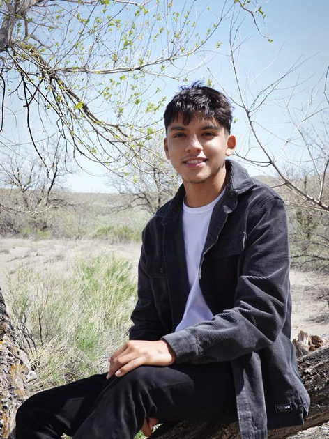  Young man sitting on a rock