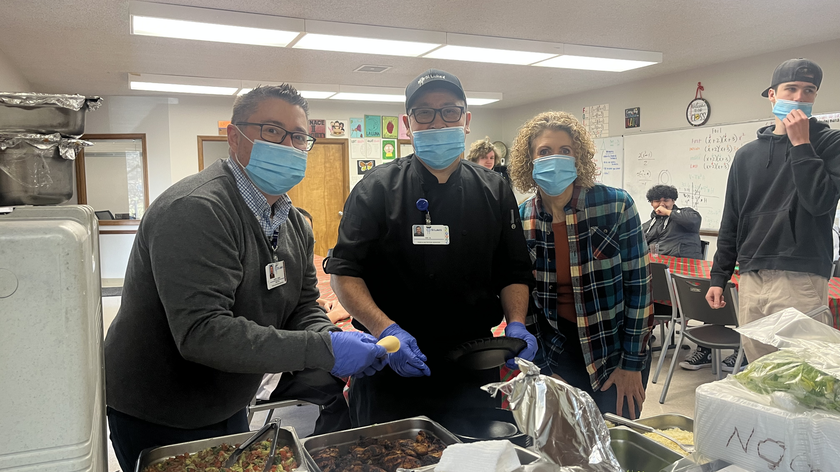 St. Luke's staff serving food to students.