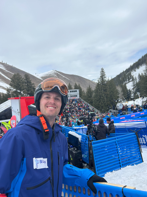  Physician in helmet and goggles standing at the finish line. 