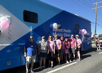 St. Luke's employees standing in front of mobile breast health unit.