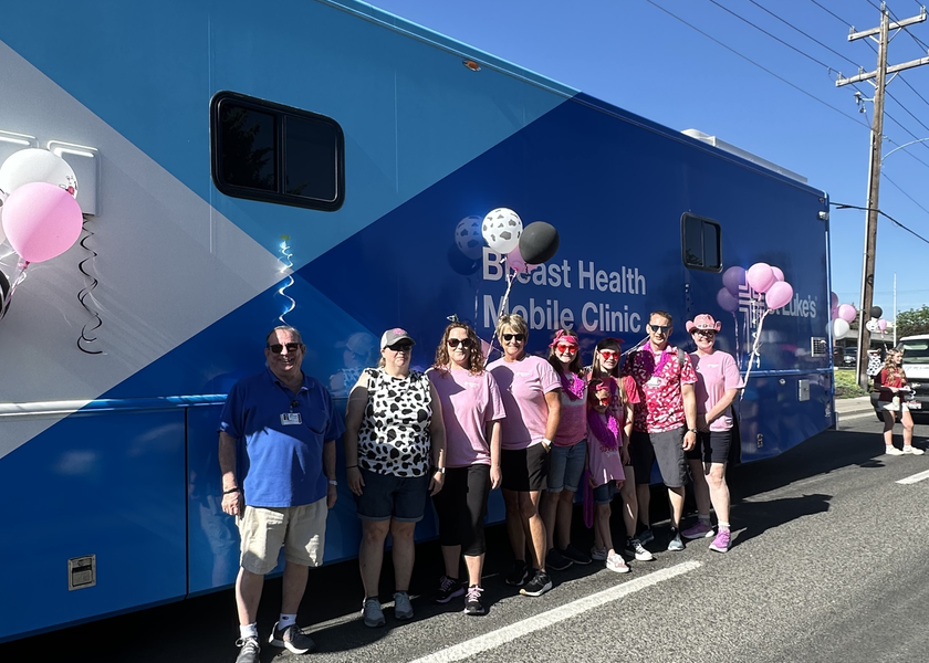 St. Luke’s employees standing in front of mobile breast health unit. 