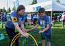Mom and son playing a hula hoop yard game