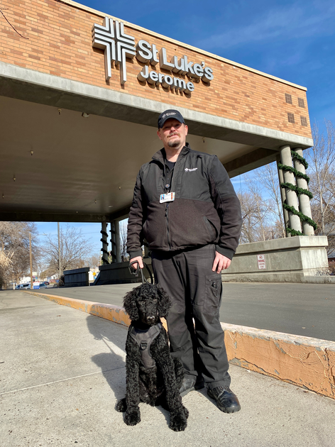  Bolt and security officer pose in front of the Jerome hospital.
