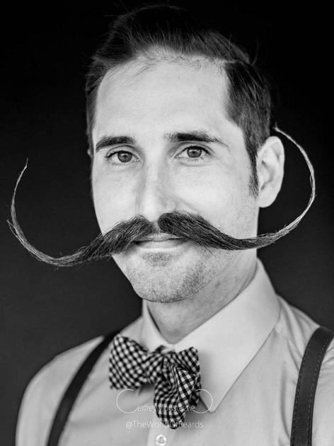  Black and white photo of man with large mustache