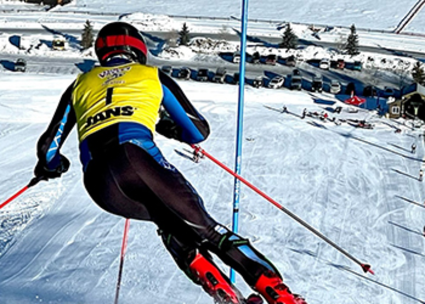  Skier facing down a mountain