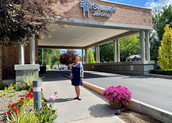Smiling woman in front of hospital bay