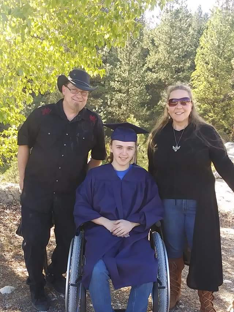 Young man in wheelchair with parents