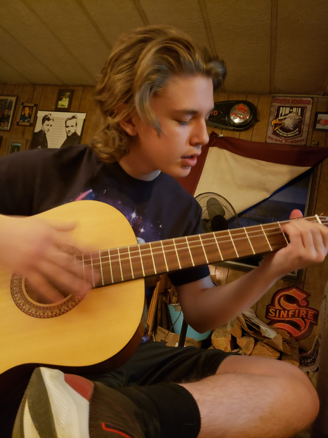 Young man strums guitar