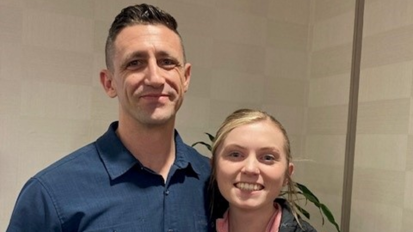 Two people smile at camera