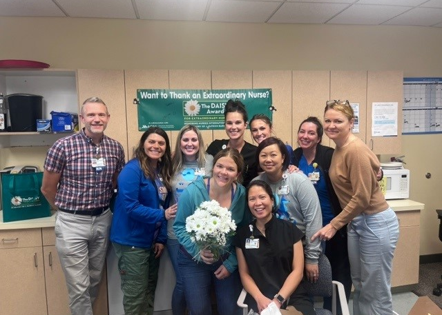 Healthcare team surrounds woman with flowers