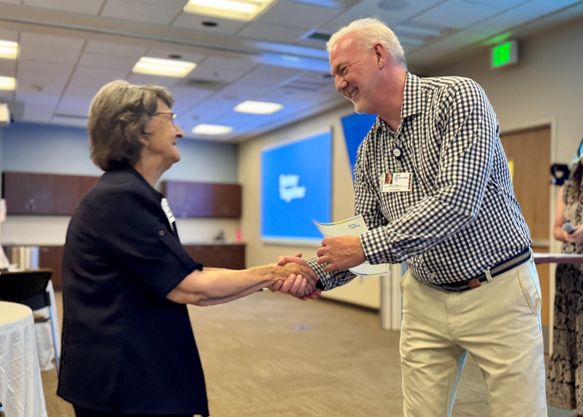 Sister Rose Mary Boessen greeting a St. Luke's staff member