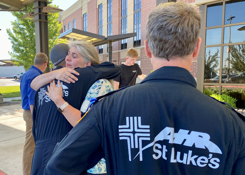 Woman hugging paramedic