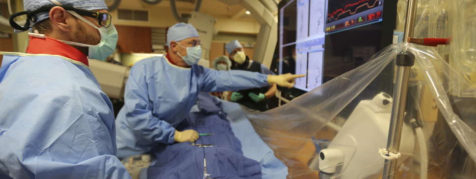 Interventional radiologists collaborate during a procedure.