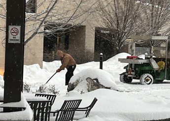 A St. Luke's employee shovels snow.