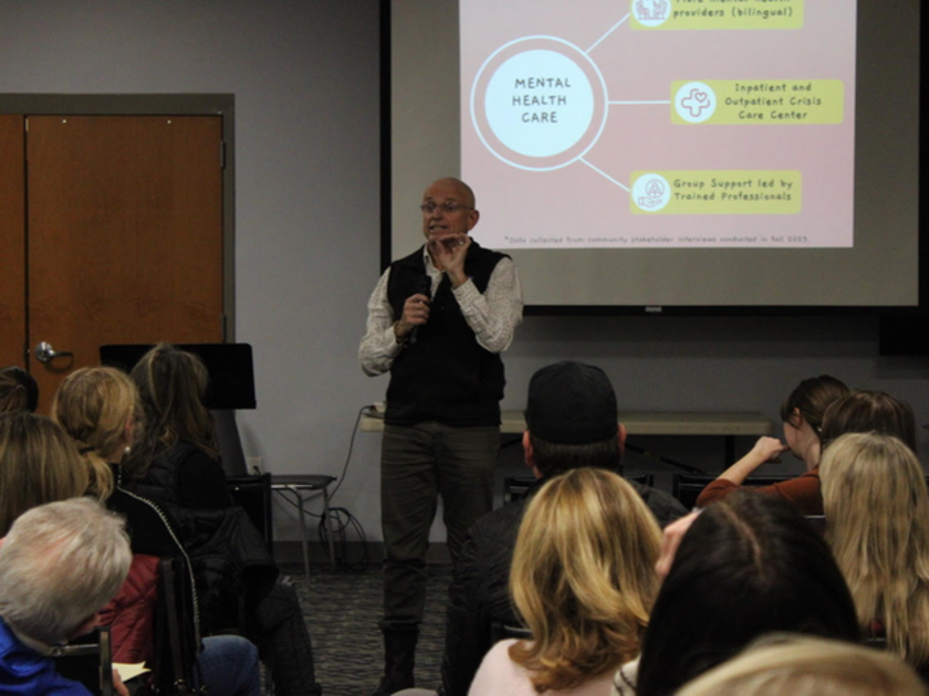 Presenter speaking in front of audience