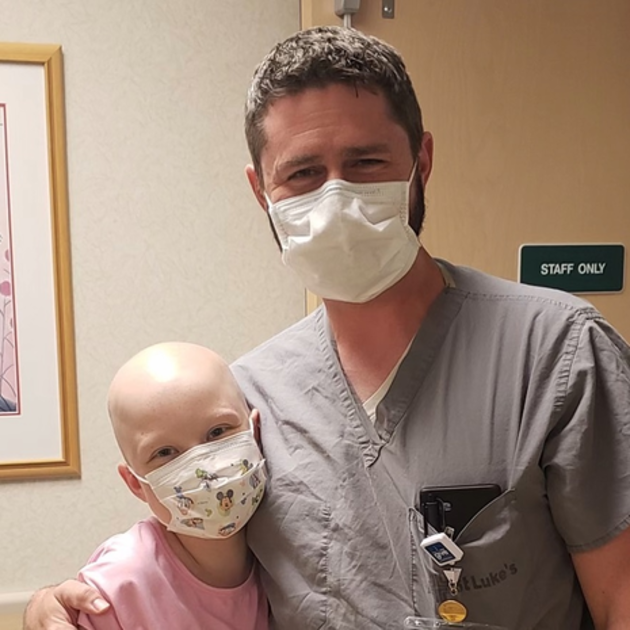 Young cancer patient pictured with physician.