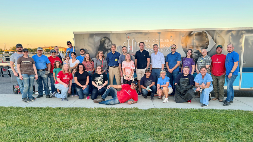 St. Luke's Magic Valley staff take a break from building beds to pose for a group photo.