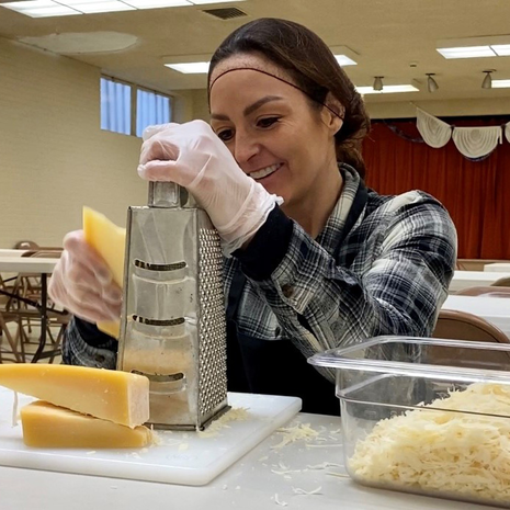 Volunteer at fundraising event smiles