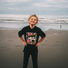 Young boy stands proudly on the beach