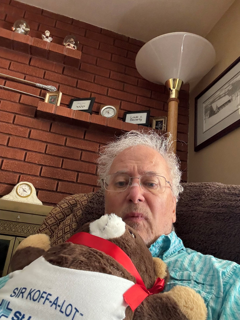  Mark holds a teddy bear while recovering from surgery.