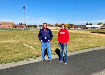 Principal and teacher on new walking track.