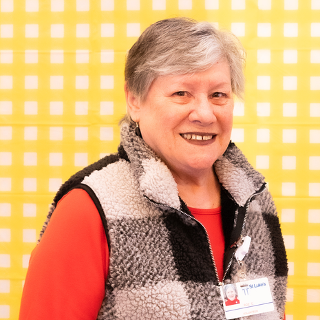 Volunteer smiles while working at St. Luke’s