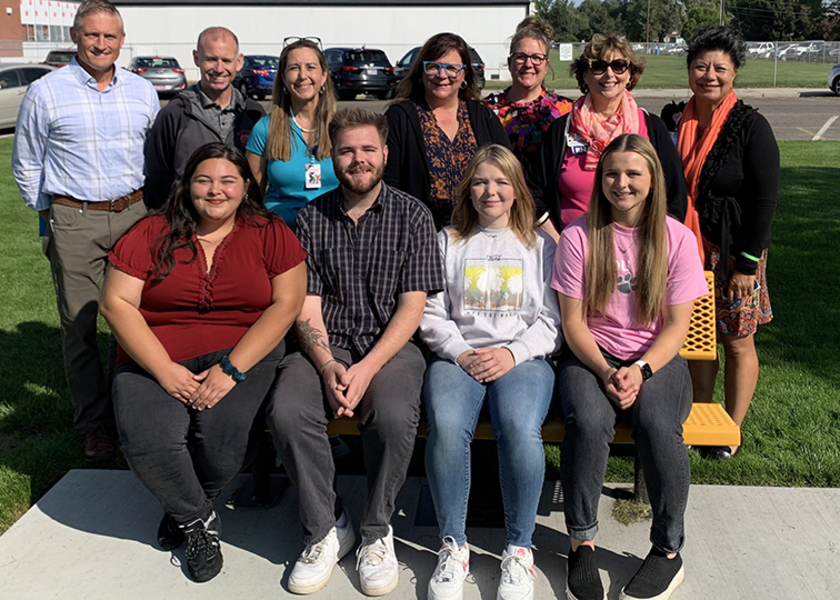 Group of people smile into the camera