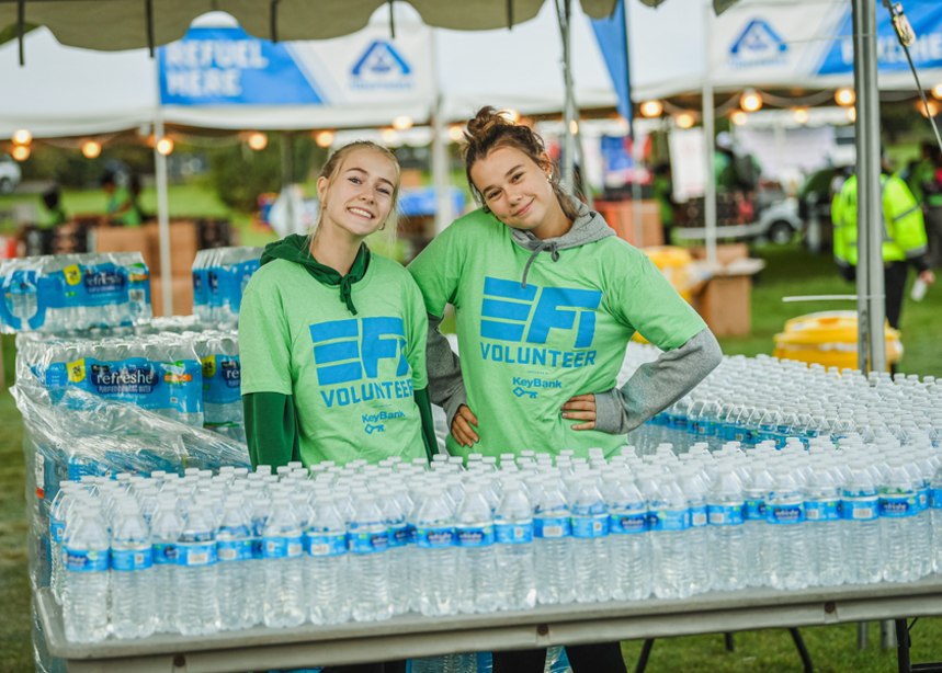 Two volunteers at the water station at FitOne Finish Festival