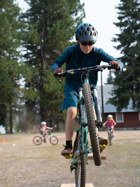 Youth in helmets riding bicycles