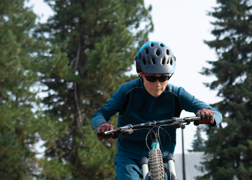  Youth in helmets riding bicycles