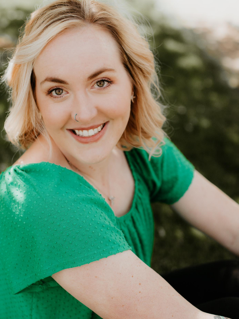Paige sitting in the grass.