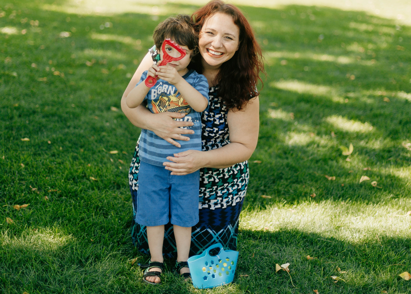 Patricia hugging a child.