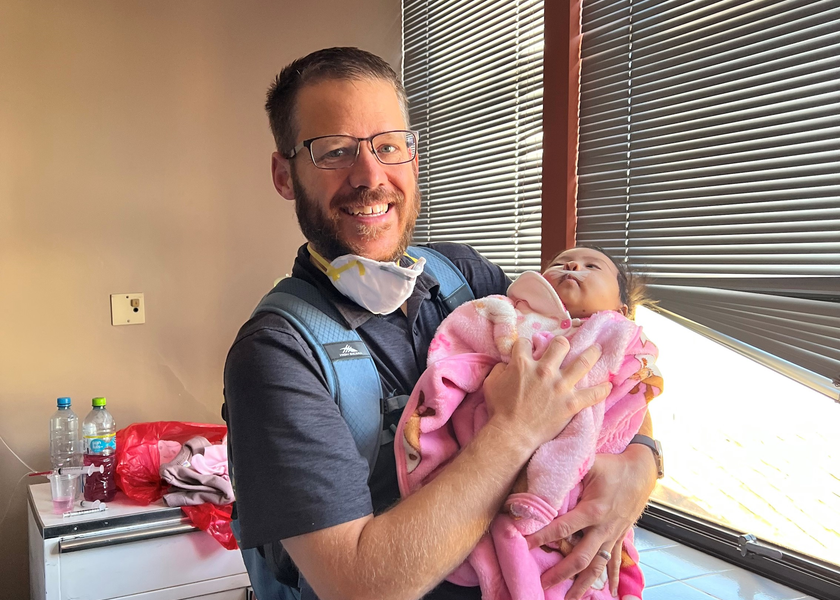 Doctor holding infant patient.