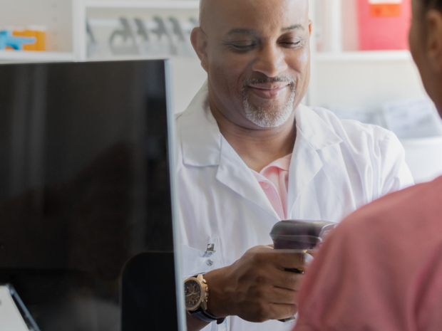 Pharmacist scanning prescription