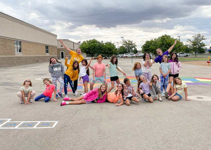 Girls on the Run participants smiling and waving